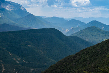 beautiful view of mountain tops and white clouds against blue sky in Vercors, pre-Alps region in France