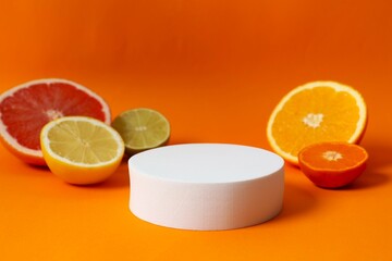 Tropical fruits with podium on a colored background. Summer concept. Flat lay, top view, copy space