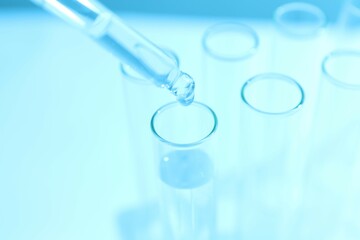 Laboratory test tubes on colored background