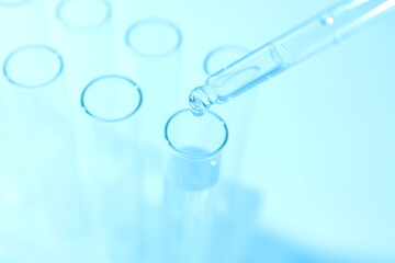 Laboratory test tubes on colored background