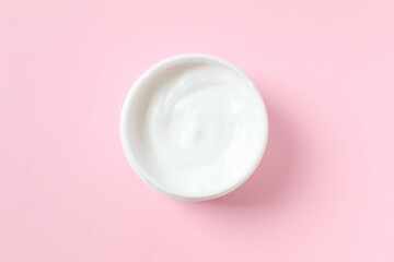 Moisturizing care skincare face cream for healing complicated troubled skin type in an open jar with visible texture