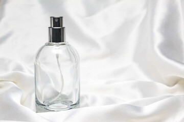 perfume bottle on satin fabric with negative space
