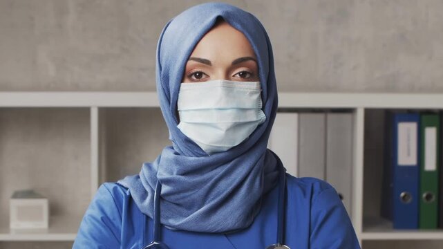 Professional medical doctor working in hospital office, Portrait of young and attractive female physician in protective mask. Medical concept.