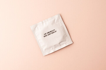 Condom on pink colored background. Mens contraception. Sexually transmitted diseases infections...