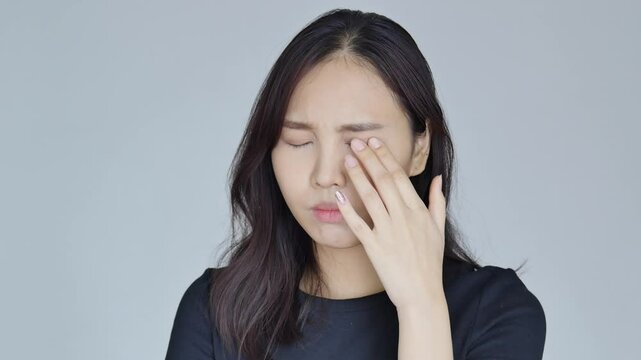 asian woman suffering from irritated eye; concept of optical health care, red eye allergy, eye care, allergic or itching or dry eye inflammation; young adult asian woman model