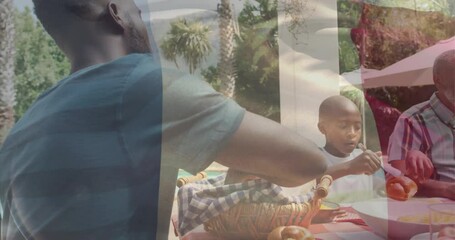 Animation of flag of france over african american family eating dinner together - Powered by Adobe