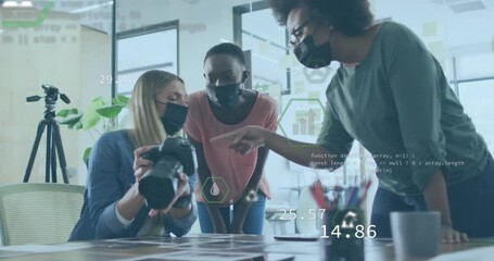 Animation of data over diverse business people wearing face masks in office - Powered by Adobe