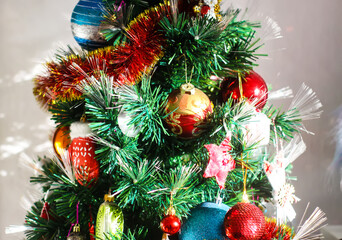 Artificial Christmas tree with traditional decor.