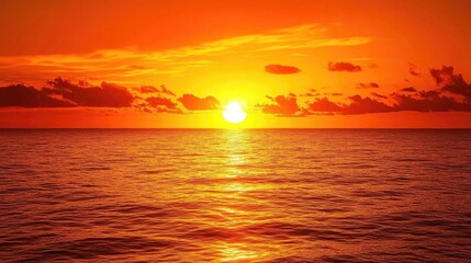 Fototapeta premium A vibrant orange sunset over a calm ocean, with the sky painted in shades of orange, creating a serene and breathtaking scene.