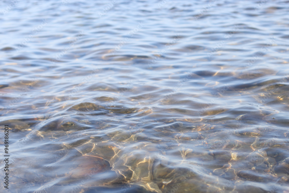 Poster A close-up shot of a body of water with rocks surrounding it, great for use as a background or decorative element