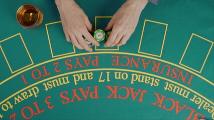Gaming and casino payment concept. Top view of blackjack casino table with open cards and chips, woman betting few chips on cards.