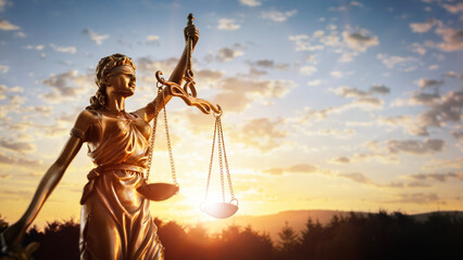 Legal law concept statue of Lady Justice with scales of justice and sunset sky background