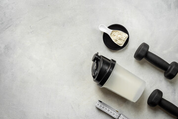 Protein shaker for sports nutrition. Whey protein powder in a scoop, top view