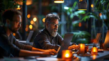 Focused professionals working late in modern office with warm ambient lighting