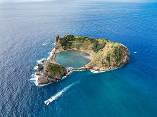 Aerial drone view of picturesque tropical Vila Franca do Campo Islet and a motorboat. Volcanic...