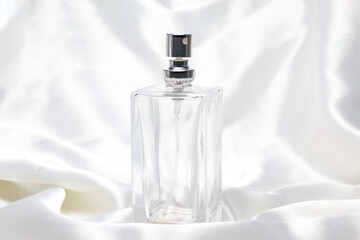 perfume bottle on satin fabric with negative space