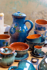 Various ceramic jug, mugs and plates at a street market. Handmade