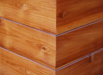 Natural colored wood panels arranged at right angles. You can clearly see the wood grain.

