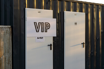 Portable toilet for artists placed on the backstage of a concert to provide convenience during live events and performances