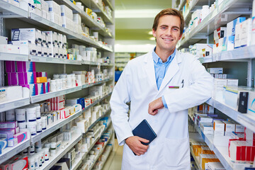 Pharmacist, confident and portrait in store for medicine, inventory and trust with healthcare service. Happy man, notebook and shelf in pharmacy for wellness prescription, pills and health supplement