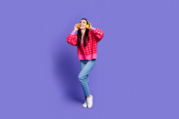 Full length photo of shiny attractive lady dressed pink cardigan earphones enjoy music empty space isolated violet color background