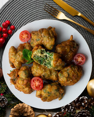 Spinach fritters, traditional Spanish tapa. Top view table with Christmas decoration.