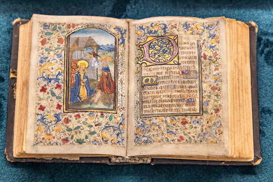 Prague, Czech Republic - May 30, 2024: Detail of a handwritten bible with Latin script and gold flourishes