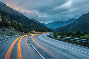 Fototapeta premium A road in the mountains with traffic lights creates the effect of long exposure.
