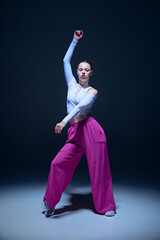 Full-length of emotional, beautiful, joyful young girl, hip hop dancer in motion, performing...