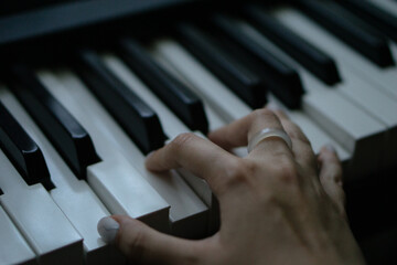 Fototapeta premium Piano keys person plays classical music black and white