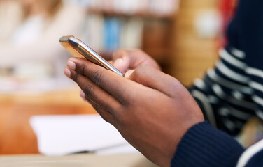 Phone, library and hands of man at university for education, communication or online chat for...