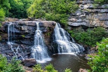 Stunning Blackwater Falls State Park cascading over rocky cliffs surrounded by lush green forest