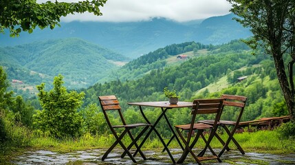 A table and chairs set with a mountain backdrop