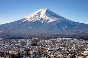 view of Mount Fuji with snowy peak and a clear blue sky overlooking Fujikawaguchiko in Japan