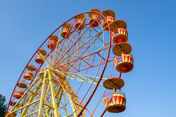 Atraction Ferris Wheel close-up on a sunny July afternoon. Vyazma. Smolensk region, Russia
