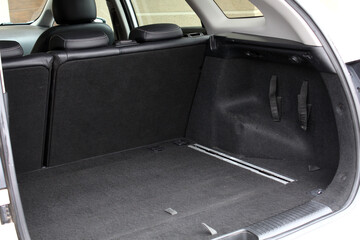 Premium car open trunk. Open empty trunk in the modern SUV. Car boot space shot. Modern SUV open...