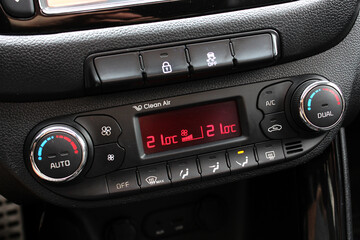 Detail air conditioning button inside a car. Dual-zone car climate control. Climate control dashboard display. Modern car air conditioner. Car interior details.