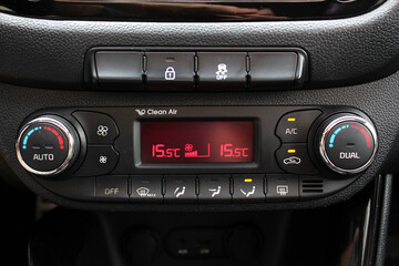 Fototapeta premium Detail air conditioning button inside a car. Dual-zone car climate control. Climate control dashboard display. Modern car air conditioner. Car interior details.