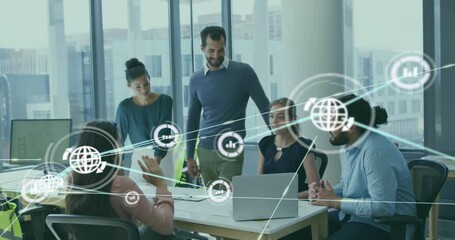 Animation of network of connections with icons over diverse colleagues using laptop in office