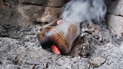 Wooden Logs That Release Smoke in the Embers of the Fire
