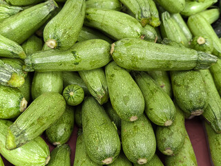 green zucchini vegetable displayed in supermarket for sale, zucchini concept