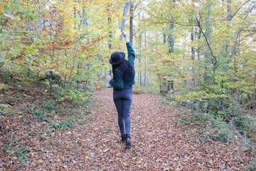 Woman walking on an autumn forest path