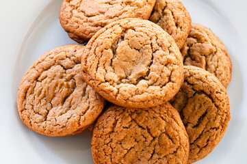 Top view of cookies stacked on a white plate