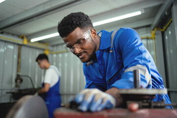 A man in a blue shirt and goggles is smiling