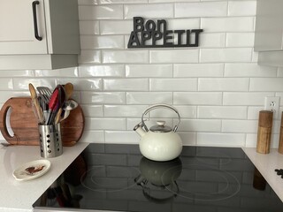 Modern kitchen with induction cooktop and utensils