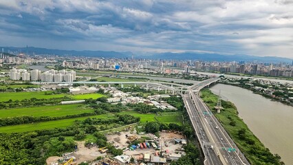 Aerial view of a cityscape with river and highways