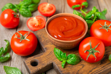 Fresh cherry tomatoes and fresh green basil on a textured background. Tomato sauce. Vegan. Ingredients for salad. Organic food. Place for text. Copy space.