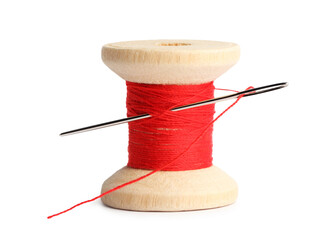 Spool of red sewing thread with needle isolated on white