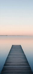 Fototapeta premium A Wooden Dock Extending into a Still Lake at Dawn