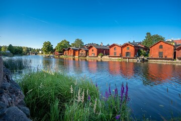 Fototapeta premium Traditional red wooden houses along the river in Porvoo, Finland